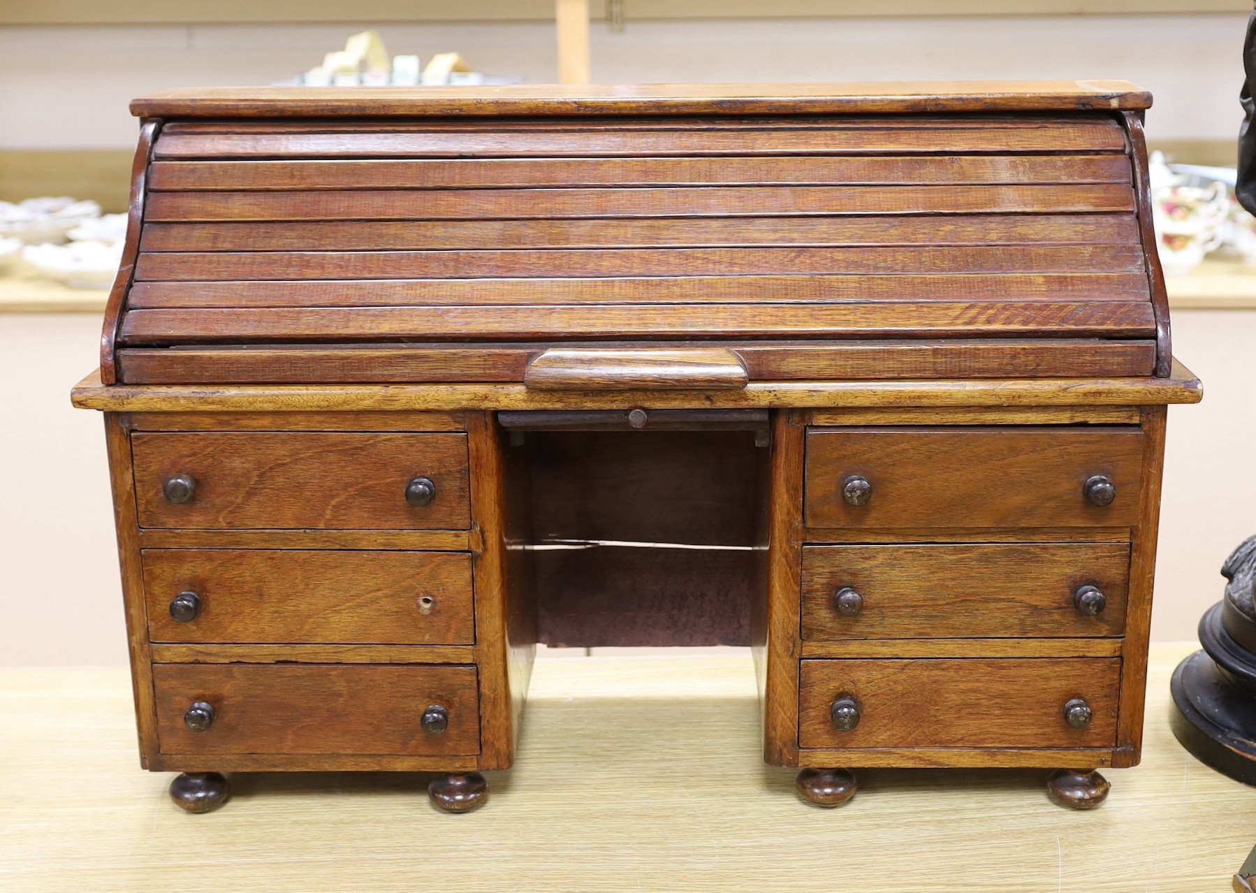 An early 20th century miniature beech tambour pedestal desk, possibly an apprentice piece, 67cms wide x 45cms high